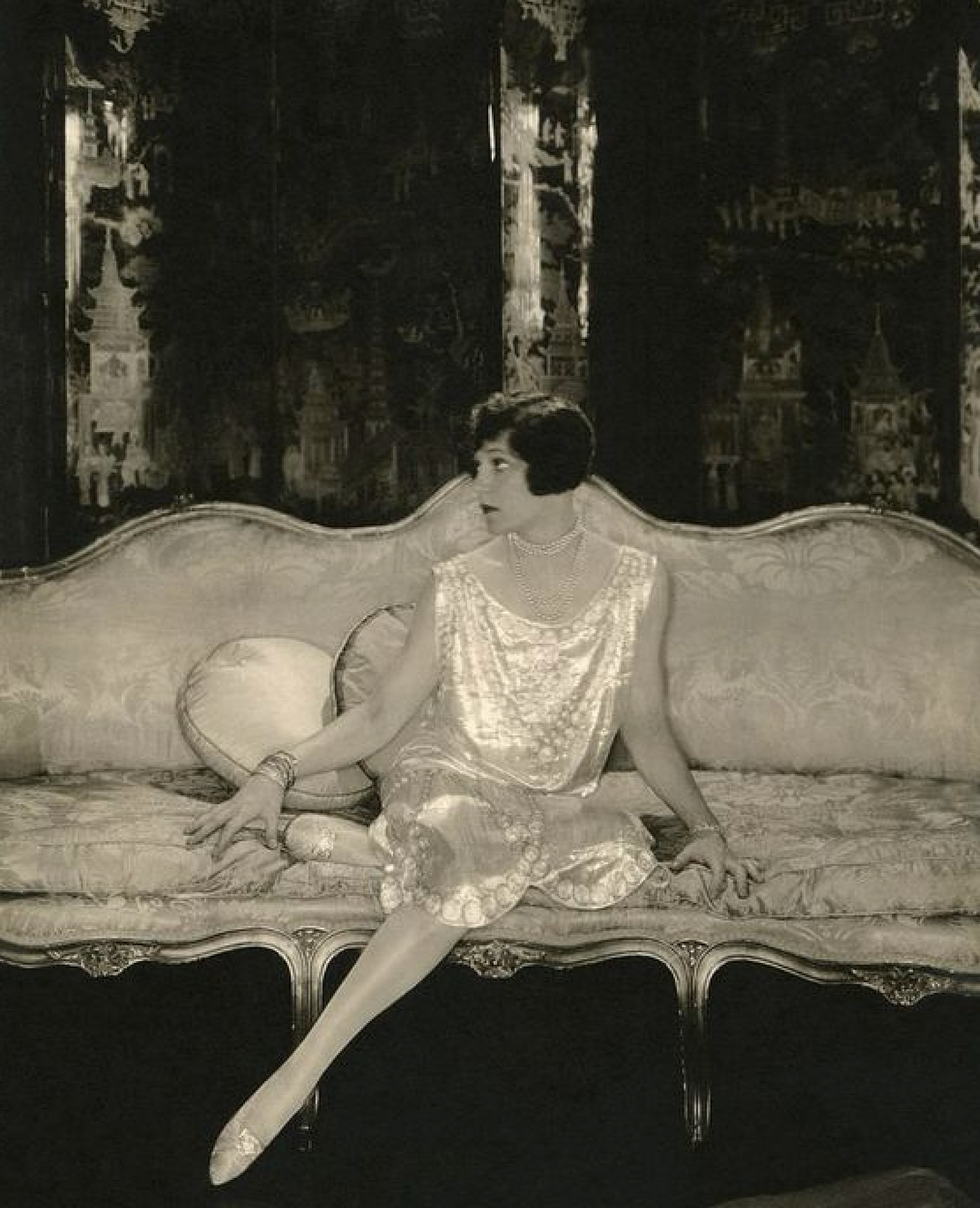 1920s art deco photo of flapper girl sitting on opulent couch found on Pinterest Matilde account